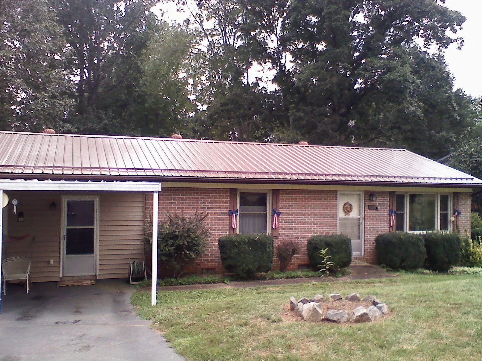 Bronze metal roof and carport on a brick ranch home — Roof Repair work by our crew in Marlborough